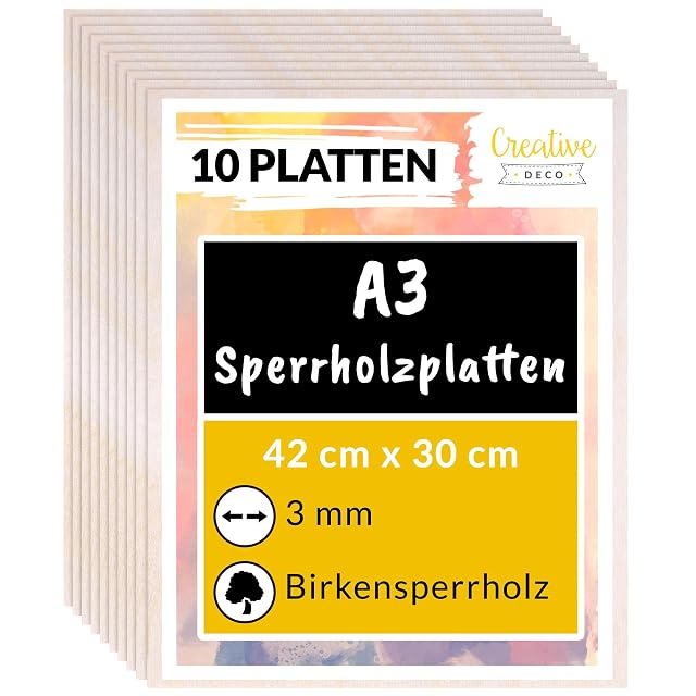 Pila de planchas de contrachapado bajo una etiqueta de Creative Deco con el texto 10 Platten, A3, 42 × 30 cm, 3 mm, Birkensperrholz